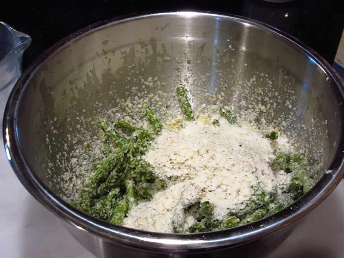Green beans in a bowl and topped with instant potato flakes.