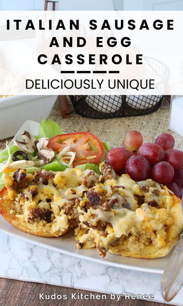 A serving of a breakfast casserole with Italian sausage, egg, and bread topped with cheese on a white plate.