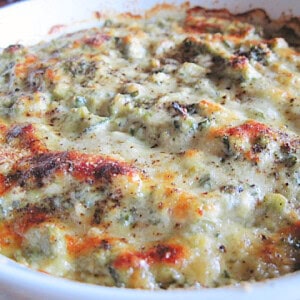 A golden melty cheesy crust on top of a spinach and artichoke dip after it came out of the oven.