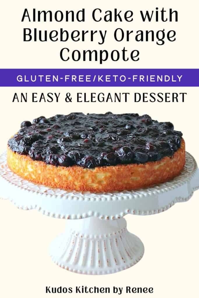 A gluten-free almond cake topped with blueberry orange compote on a pretty white cake stand with text for Pinterest.