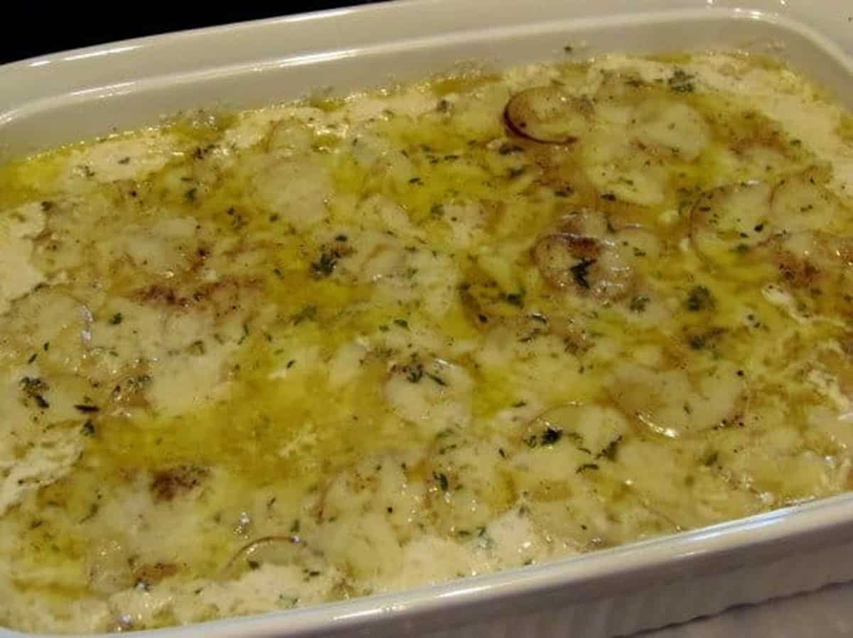 Partially baked au gratin potatoes in a casserole dish.