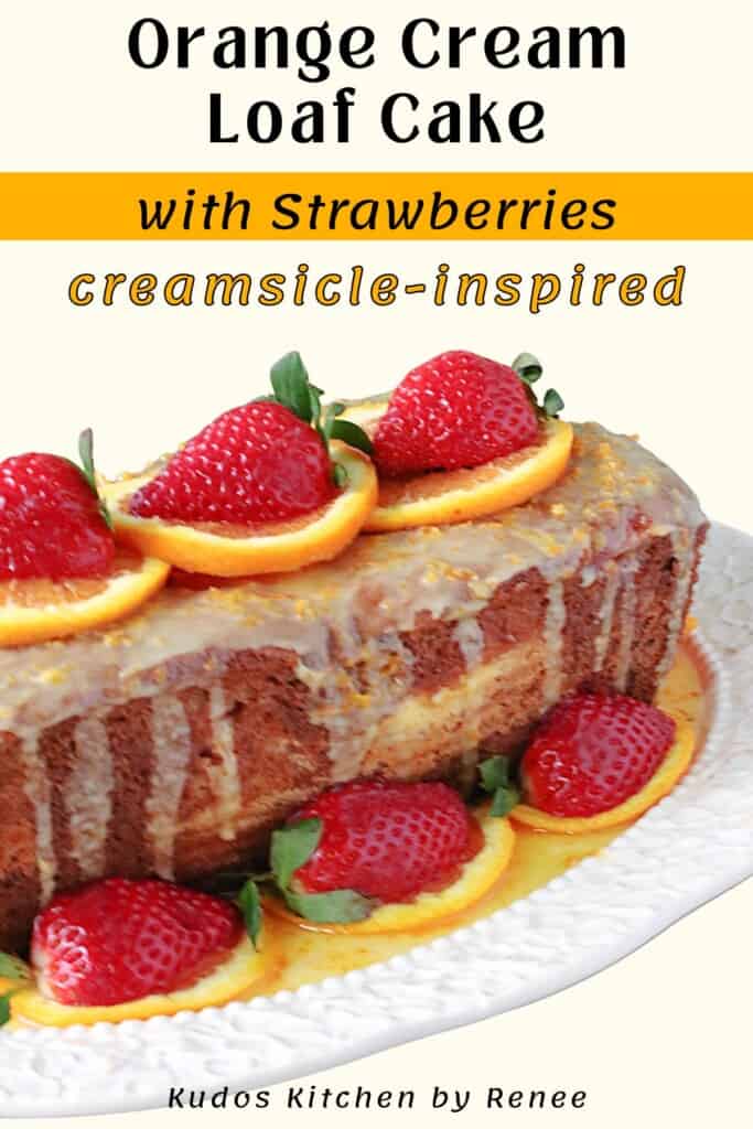 A side view of an orange cream loaf cake with an orange glaze on top.