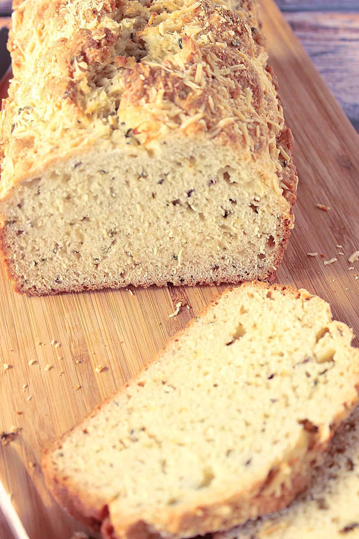 Homemade Soda Bread with Fresh Herbs An overhead look at the inside of a soda bread with fresh herbs on a cutting board.