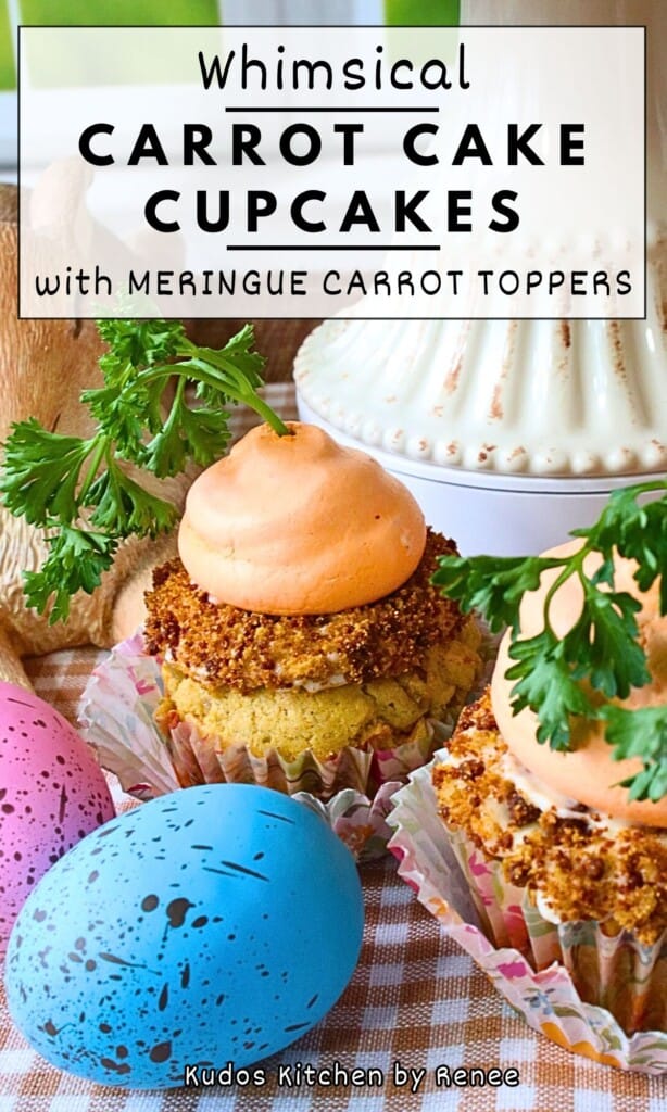 An adorable carrot cake cupcake topped with a whimsical meringue carrot that looks like it's growing in the garden.