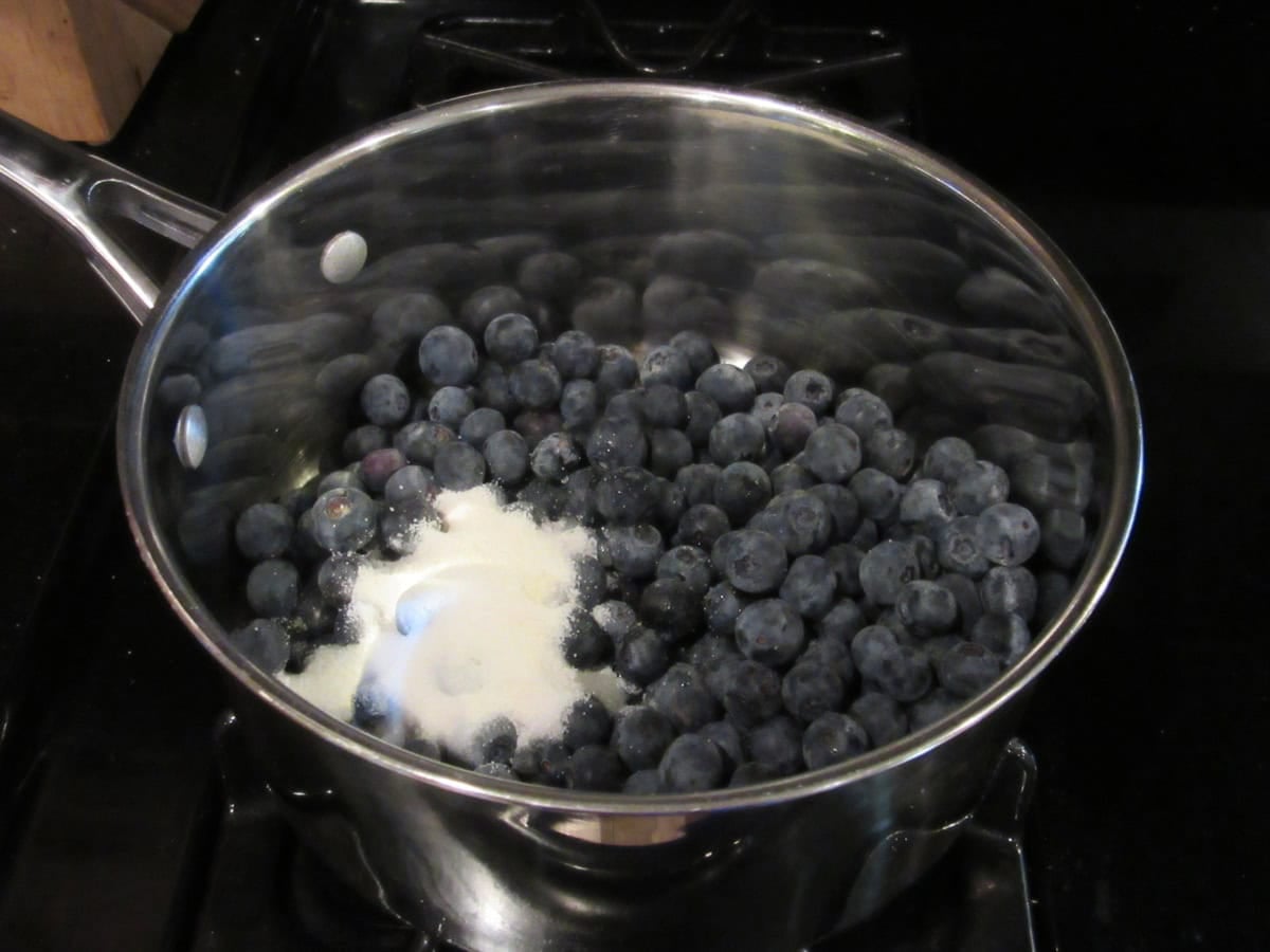 Fresh blueberries in a saucepan with sugar substitute.