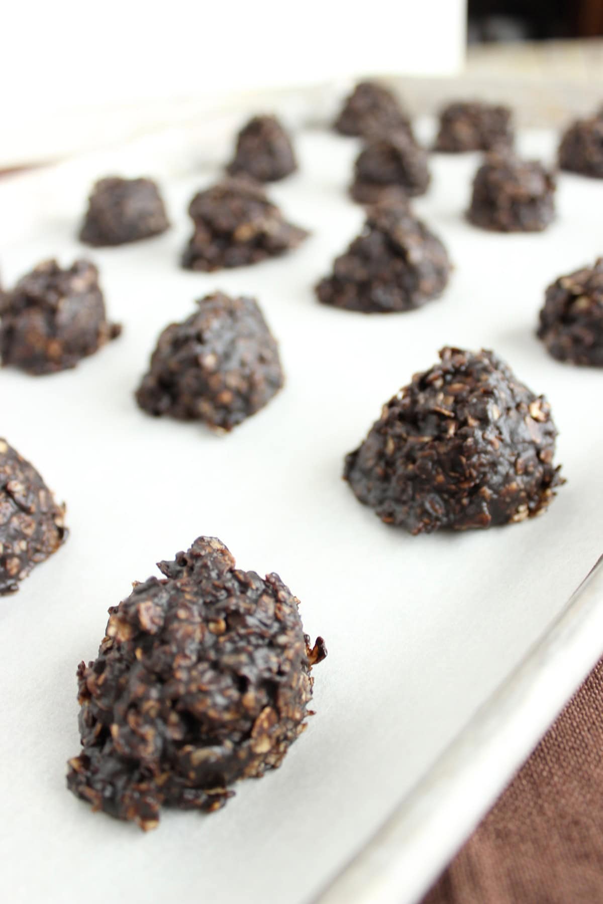 A baking sheet lined up with mounds of chocolate and peanut butter drop cookies.