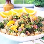 A tasty looking bowl of Asian chicken, broccoli, and mandarin oranges.