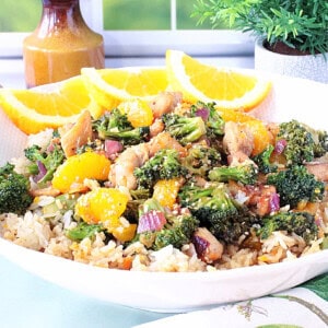 A tasty looking bowl of Asian chicken, broccoli, and mandarin oranges.