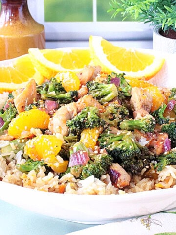 A tasty looking bowl of Asian chicken, broccoli, and mandarin oranges.