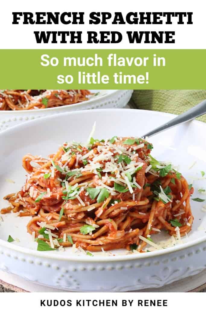 A pretty serving of French spaghetti in a bowl topped with Parmesan cheese and parsley.