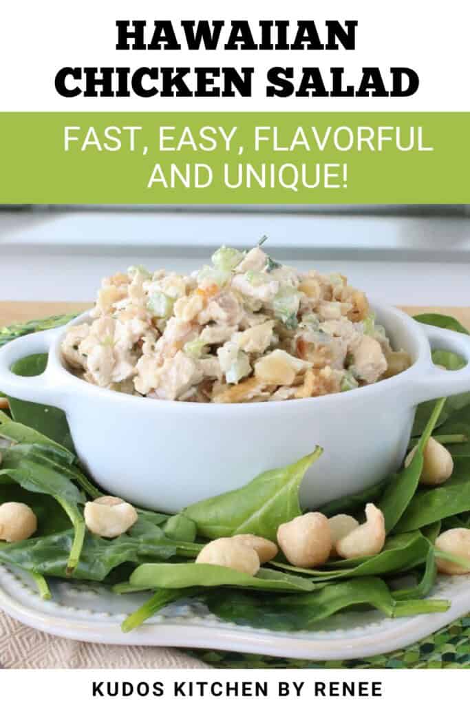 A small white bowl piled high with Hawaiian chicken salad and macadamia nuts strewn about the plate.