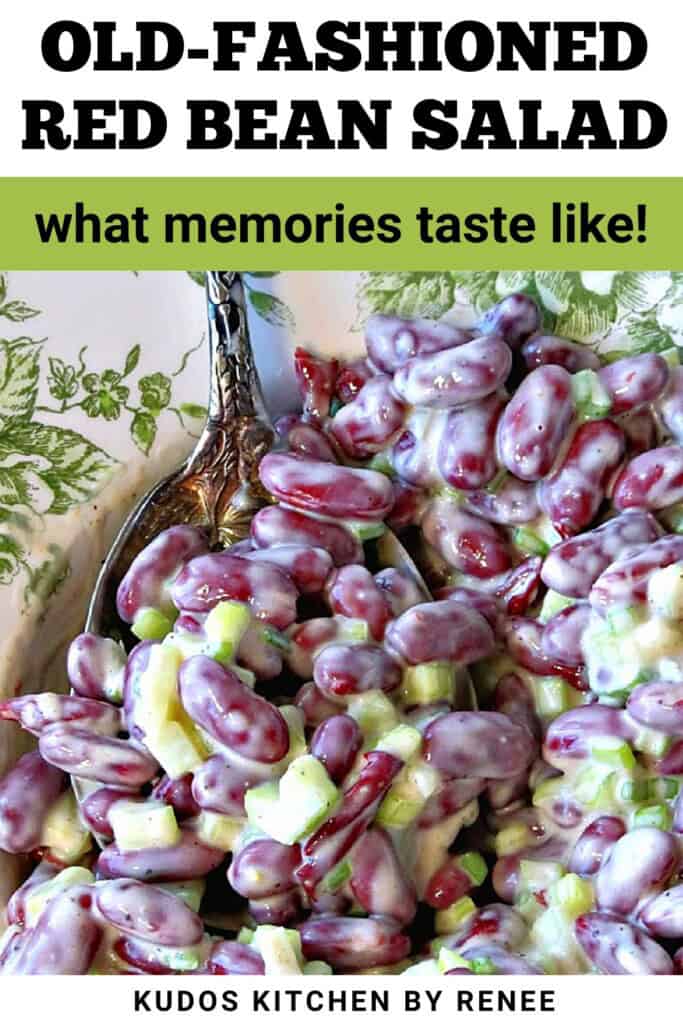 A spoon holding up a serving of creamy red bean salad with celery and scallions mixed in.