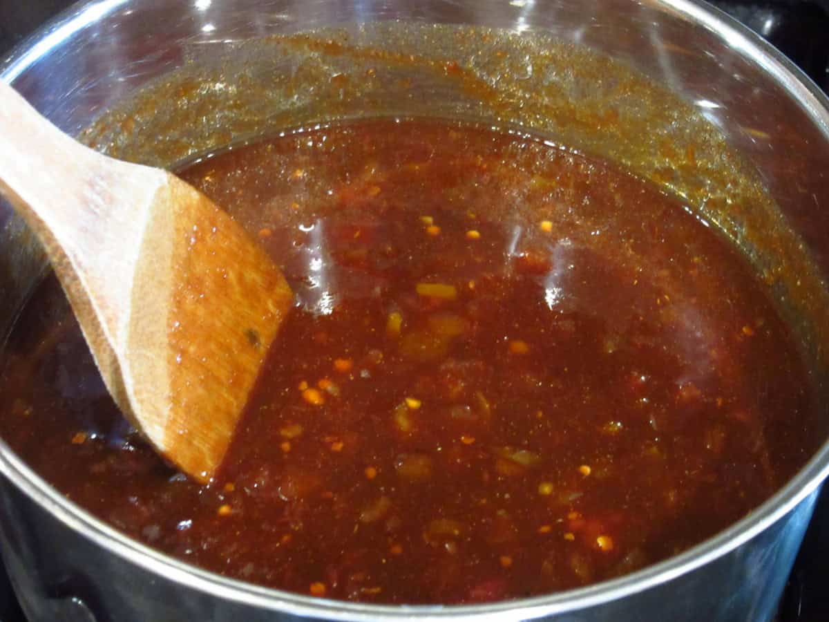 A loose salsa BBQ sauce on the stovetop before thickening.