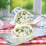 Chicken, lettuce and dressing all inside a flour tortilla wrap.