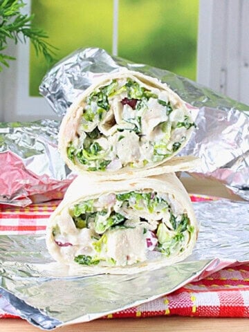 Chicken, lettuce and dressing all inside a flour tortilla wrap.