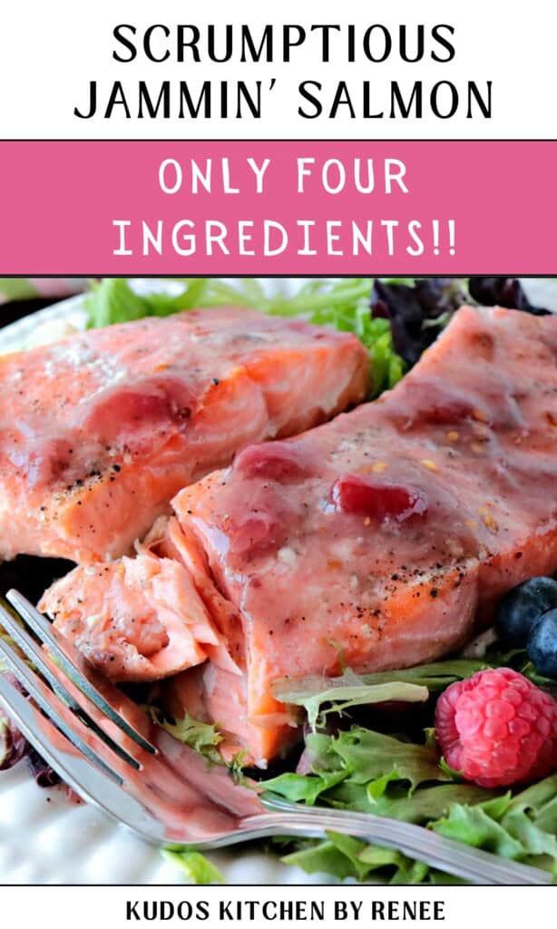 Two flaky Jammin' Salmon fish fillets covered in strawberry jam on a plate with a fork.