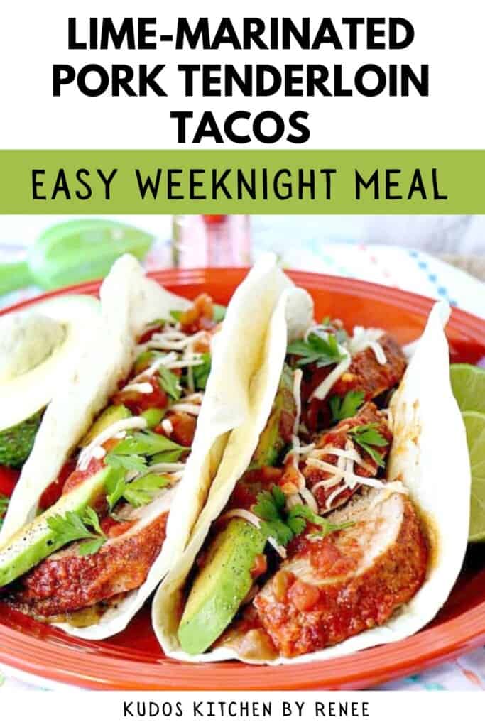 Two pork tenderloin tacos on flour tortillas with salsa and avocados on an orange plate.