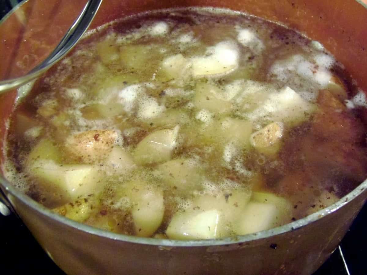 Boiling diced potatoes in water to make a traditional German Potato Salad.