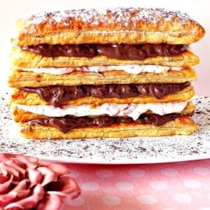 A pretty puff pastry dessert tower with layers of chocolate and cherry cream cheese.