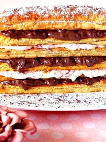 A pretty puff pastry dessert tower with layers of chocolate and cherry cream cheese.