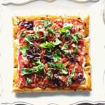 A square photo of a BLT Puff Pastry Sandwich Tart before slicing and serving.