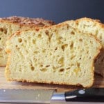 A dense looking slice of cheese jalapeno quick bread with plenty of air holes.
