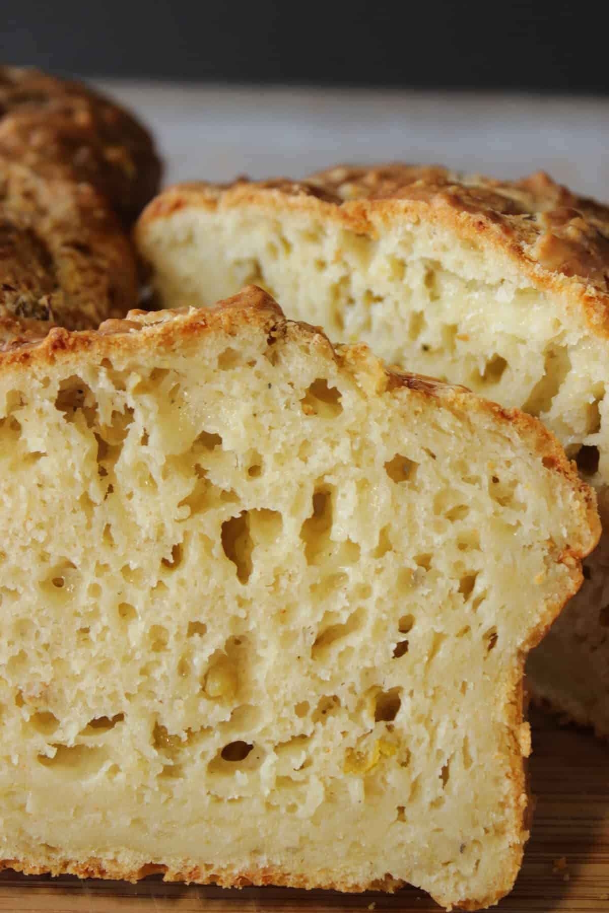 An inside look of a rich, dense cheesy jalapeno quick bread with a crispy crust.
