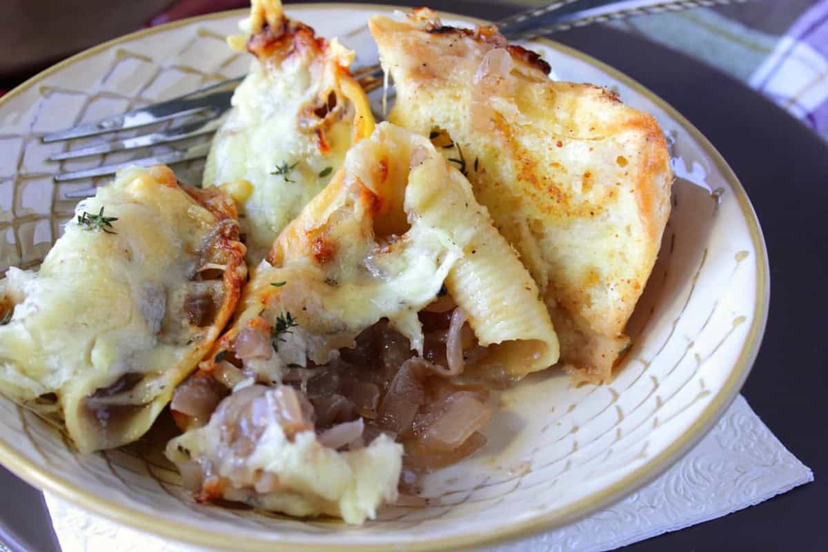 Red wine onion stuffed shells topped with cheese in a bowl.