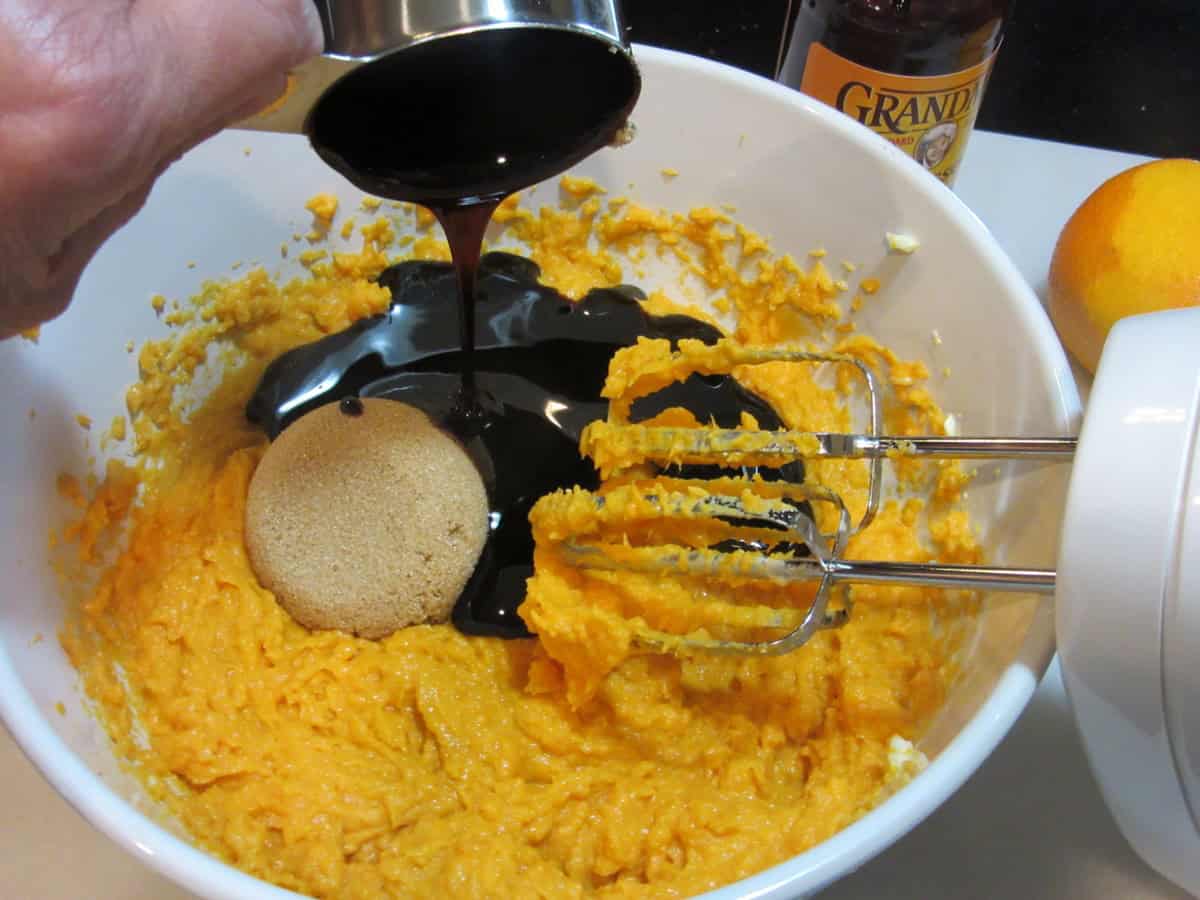 Molasses, brown sugar, and mashed sweet potatoes in a bowl.