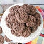 A white platter filled with a stack of delicious chocolate oatmeal cookies.