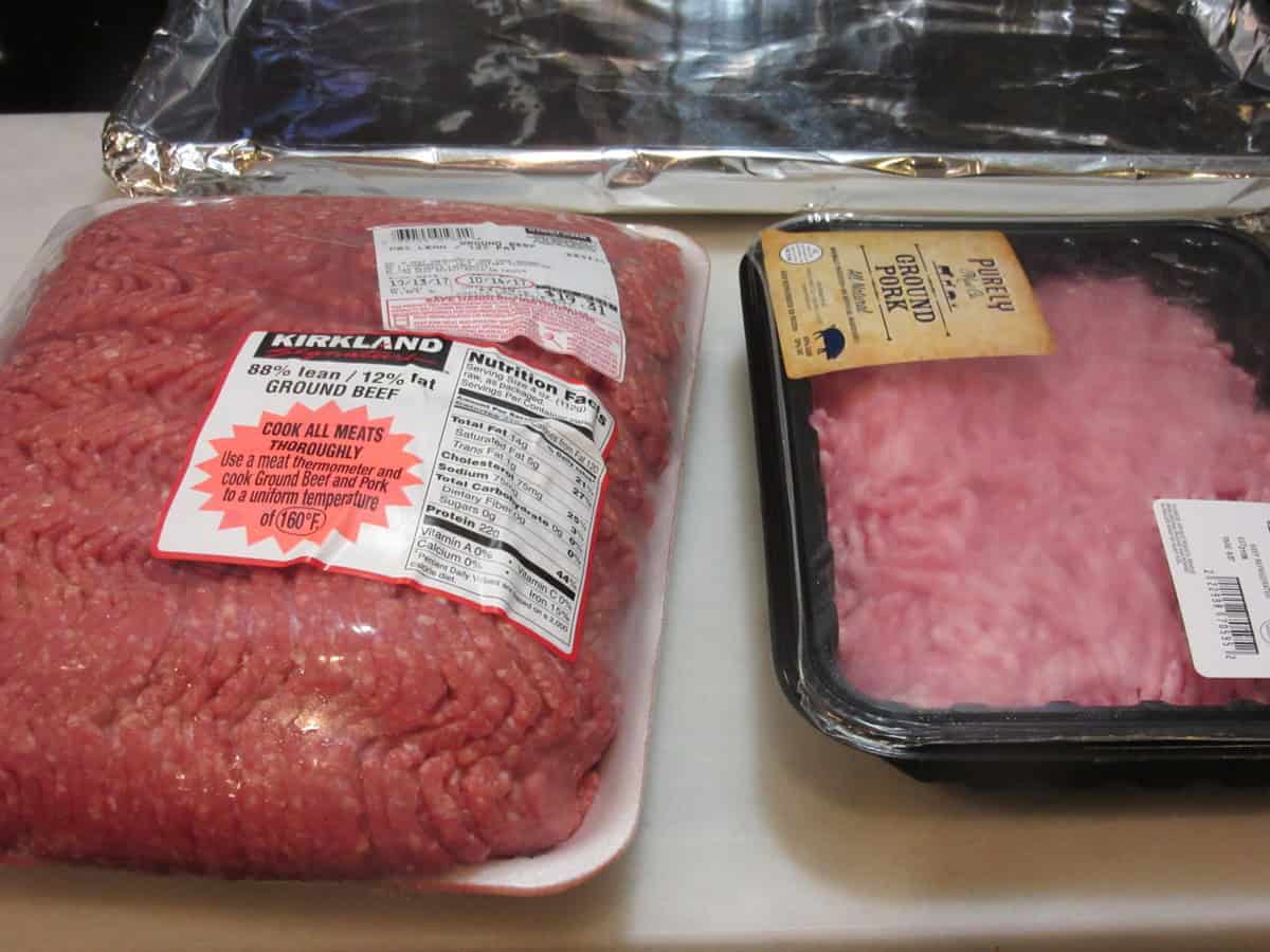 Packages of ground beef and ground pork on the counter before making meatloaf.
