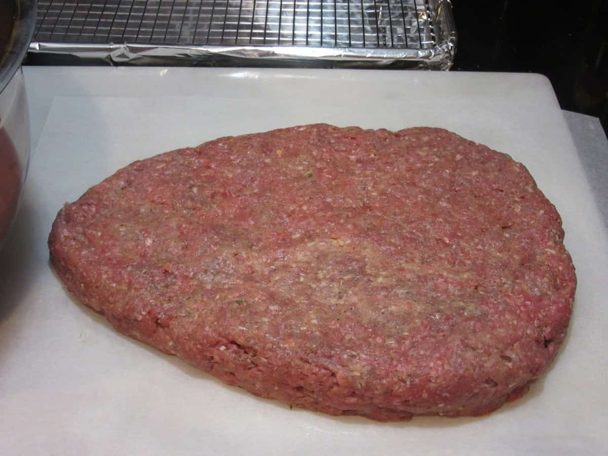 The shape of the bottom layer of meatloaf to make a rat loaf meatloaf.