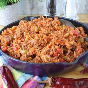 A budget family casserole of ground beef, rice, tomatoes and peppers in a skillet.
