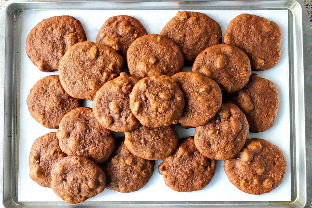 Looking for an alternative to pumpkin spice cookies this Fall? Look no further. These Amish Sweet Potato Cookies are soft and chewy with a mild spicy flavor that pairs perfectly with a cup of coffee or tea. - Kudos Kitchen by Renee A rimmed baking sheet lined with parchment paper and topped with beautiful soft Amish sweet potato cookies.
