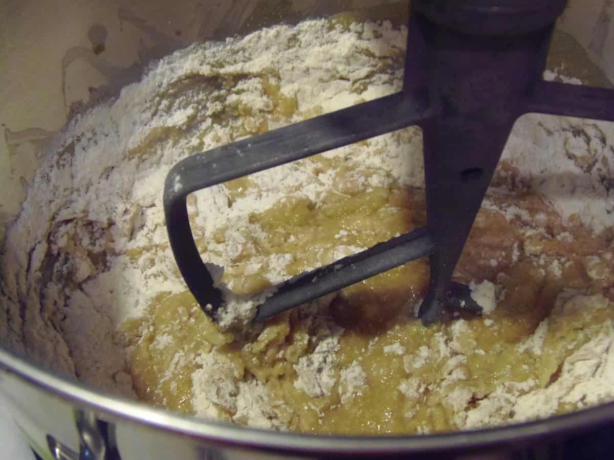 A look inside a stand mixer bowl after the wet ingredients were added to dry ingredients for making donuts.
