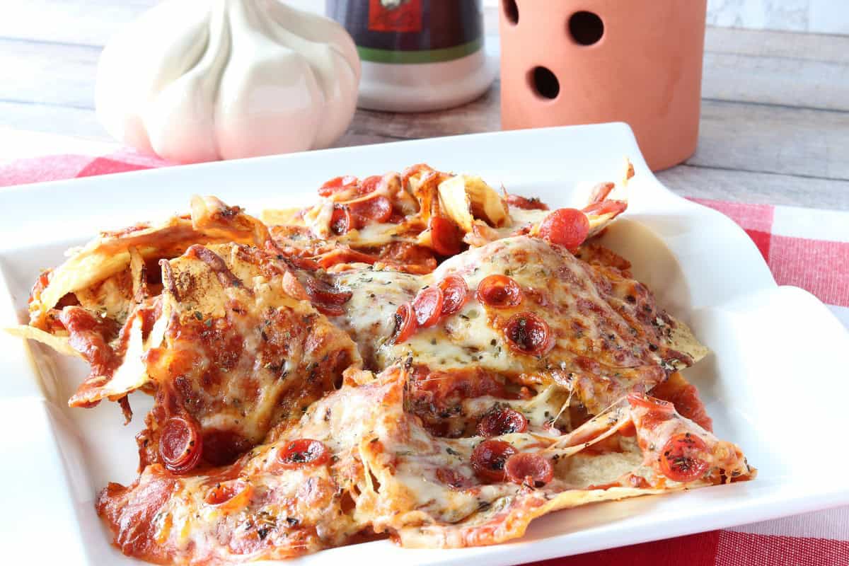 Mouthwatering pizza nachos with golden brown melted cheese on top.