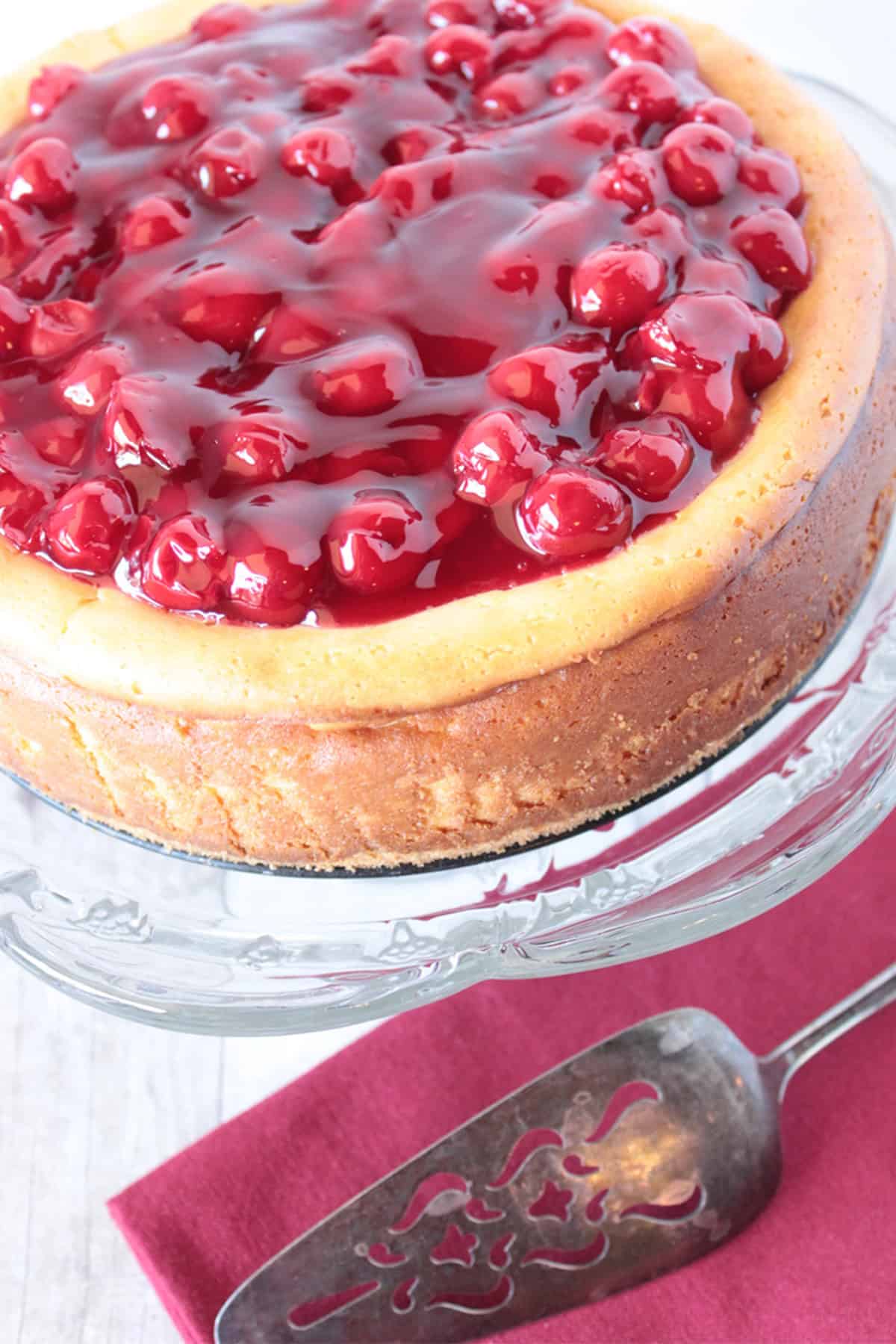 A traditional baked cherry cheesecake topped with plenty of cherry pie filling.