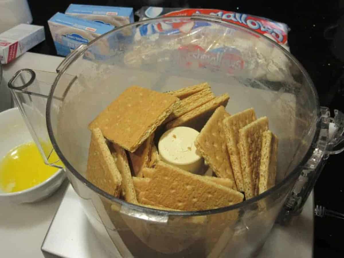 Graham crackers in a food processor bowl before processing.