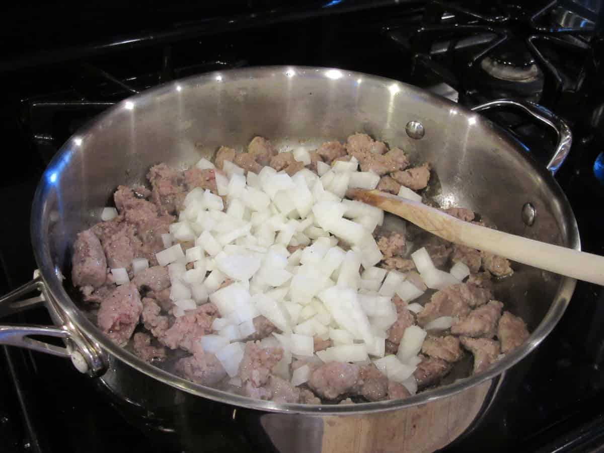 Chopped onions and cooked and crumbled bratwurst in a large skillet.