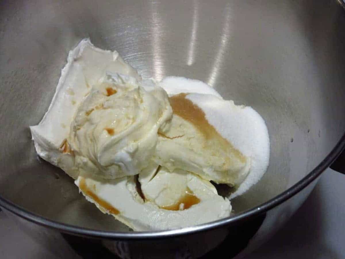 Cream cheese, sugar, vanilla extract and sour cream in the bowl of a stand mixer.