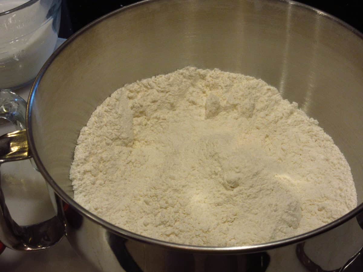Flour and salt mixed together in the bowl of a stand mixer.