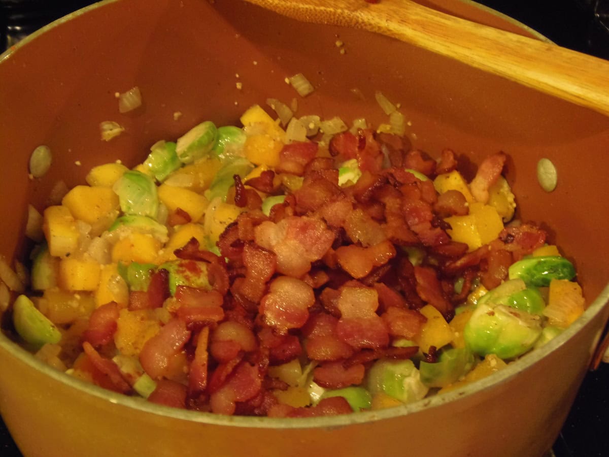 Cooked bacon and Brussels sprouts in a large stockpot.