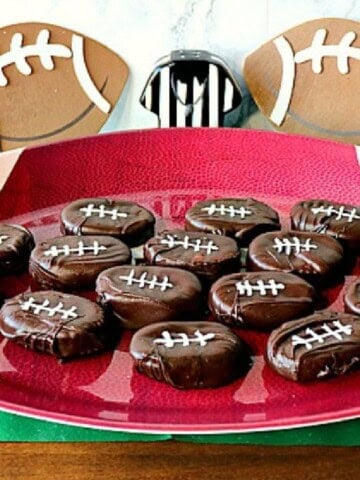 A football platter filled with chocolate and cracker football snacks.