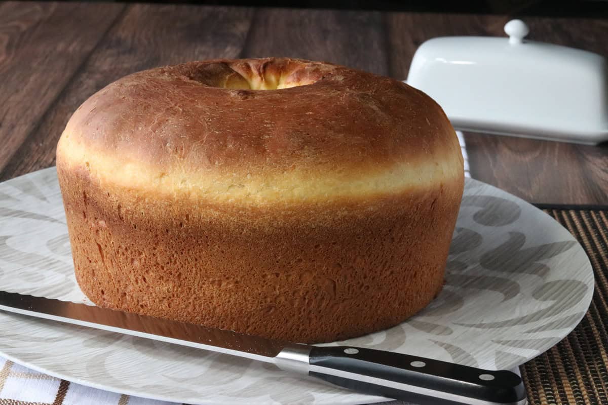 A golden brown Sally Lunn Bread that has been baked in a tube pan.