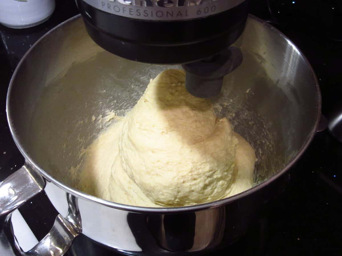 A soft dough is formed in a stand mixer bowl with a dough hook.