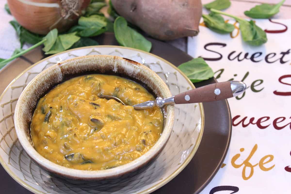 Roasted Sweet Potato Chowder with Wild Rice Chowder A spoon inside a bowl of hearty sweet potato chowder with white rice.