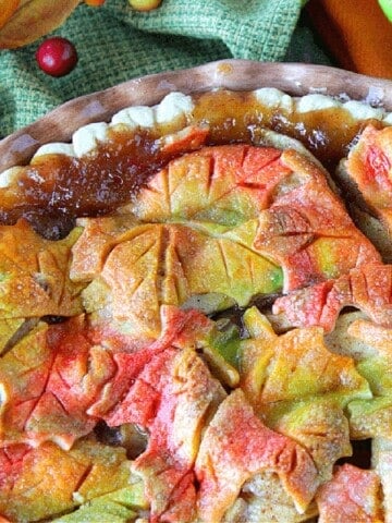 Apple pie filling that bubbled at the edge of an autumn leaves apple pie.