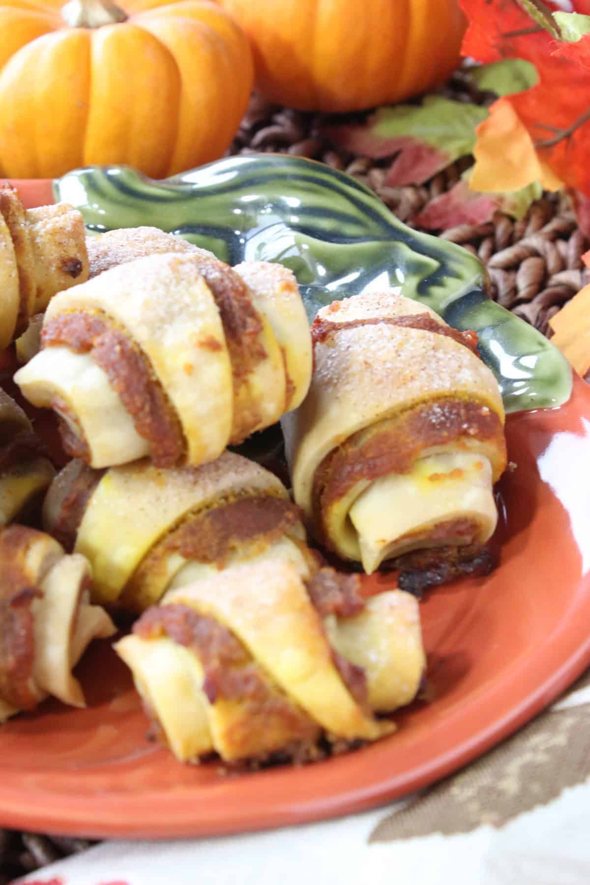 Pie crust crescent shaped desserts rolled around pumpkin pie filling.